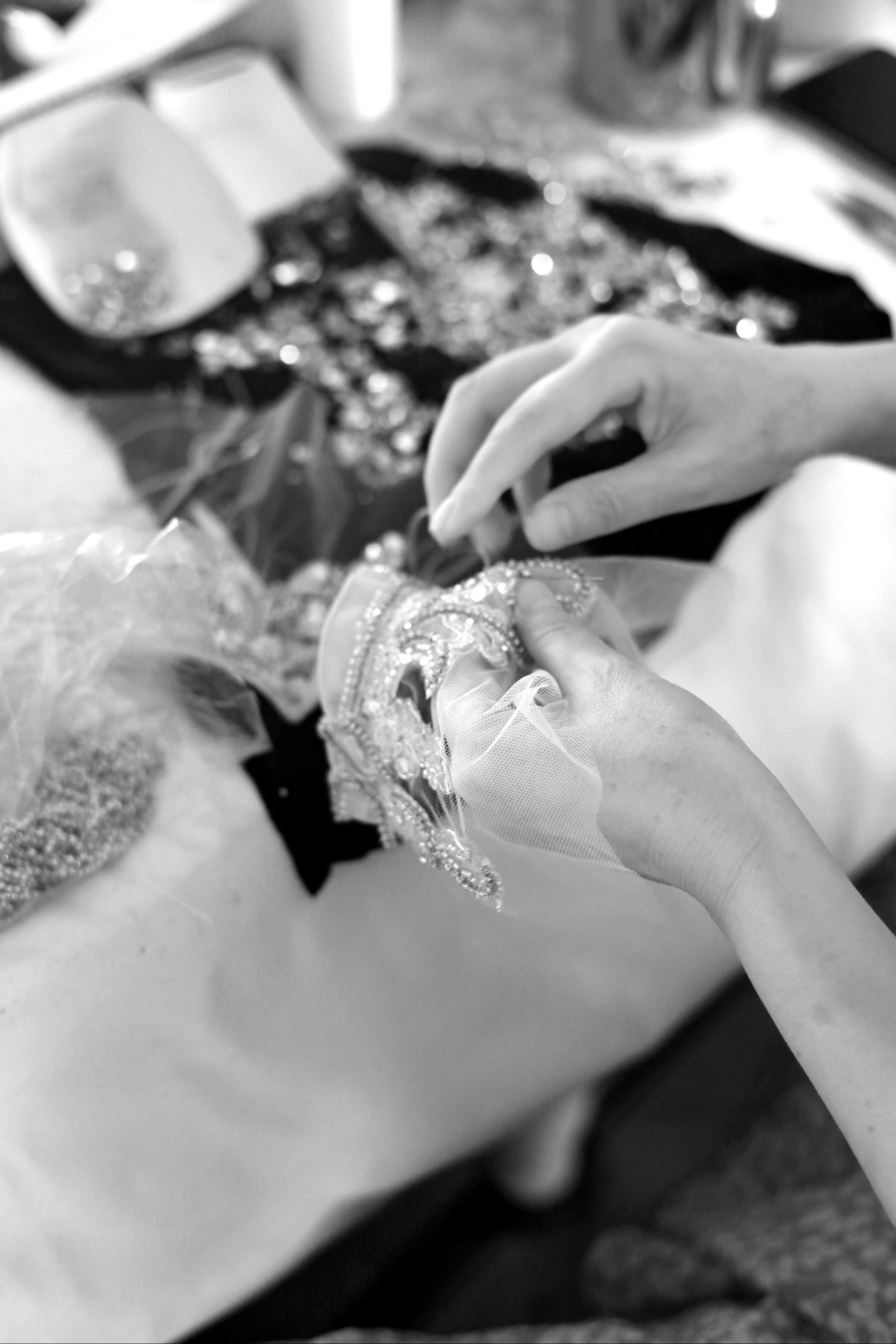 Beaded bridal appliqué being sewn by hand